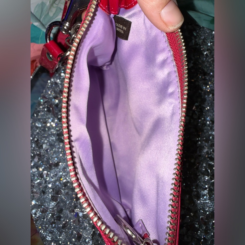 Coach Poppy Wristlet featuring a pink and purple geometric pattern. - Picture 6 of 9